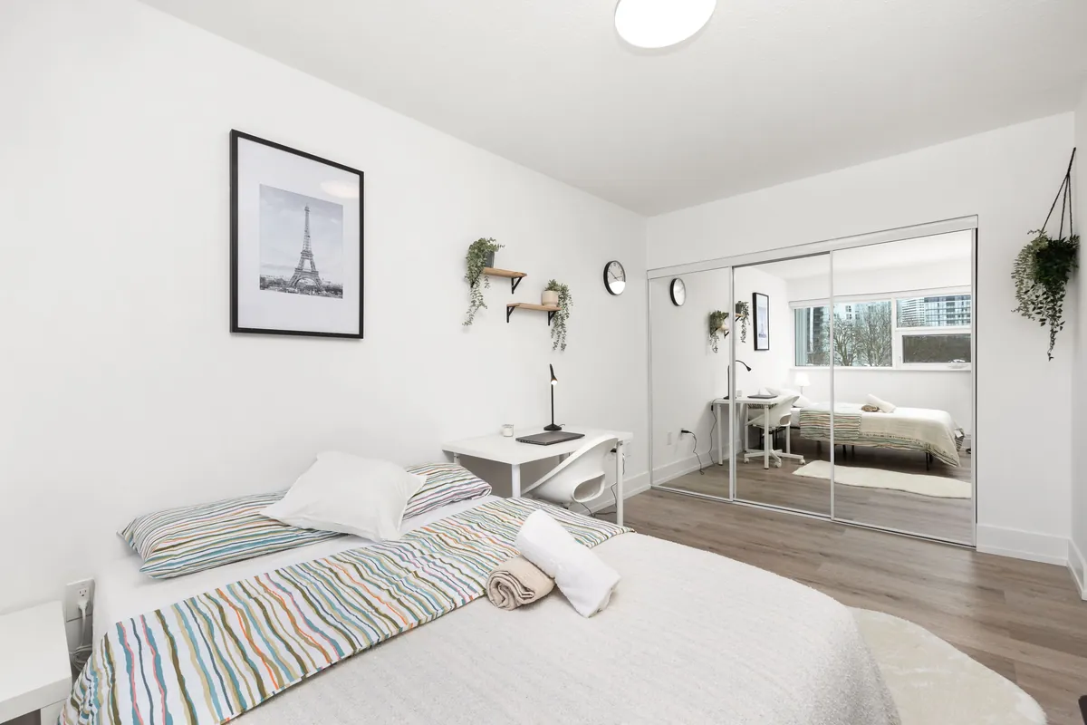 Deluxe bedroom with a full bed, framed prints and a window