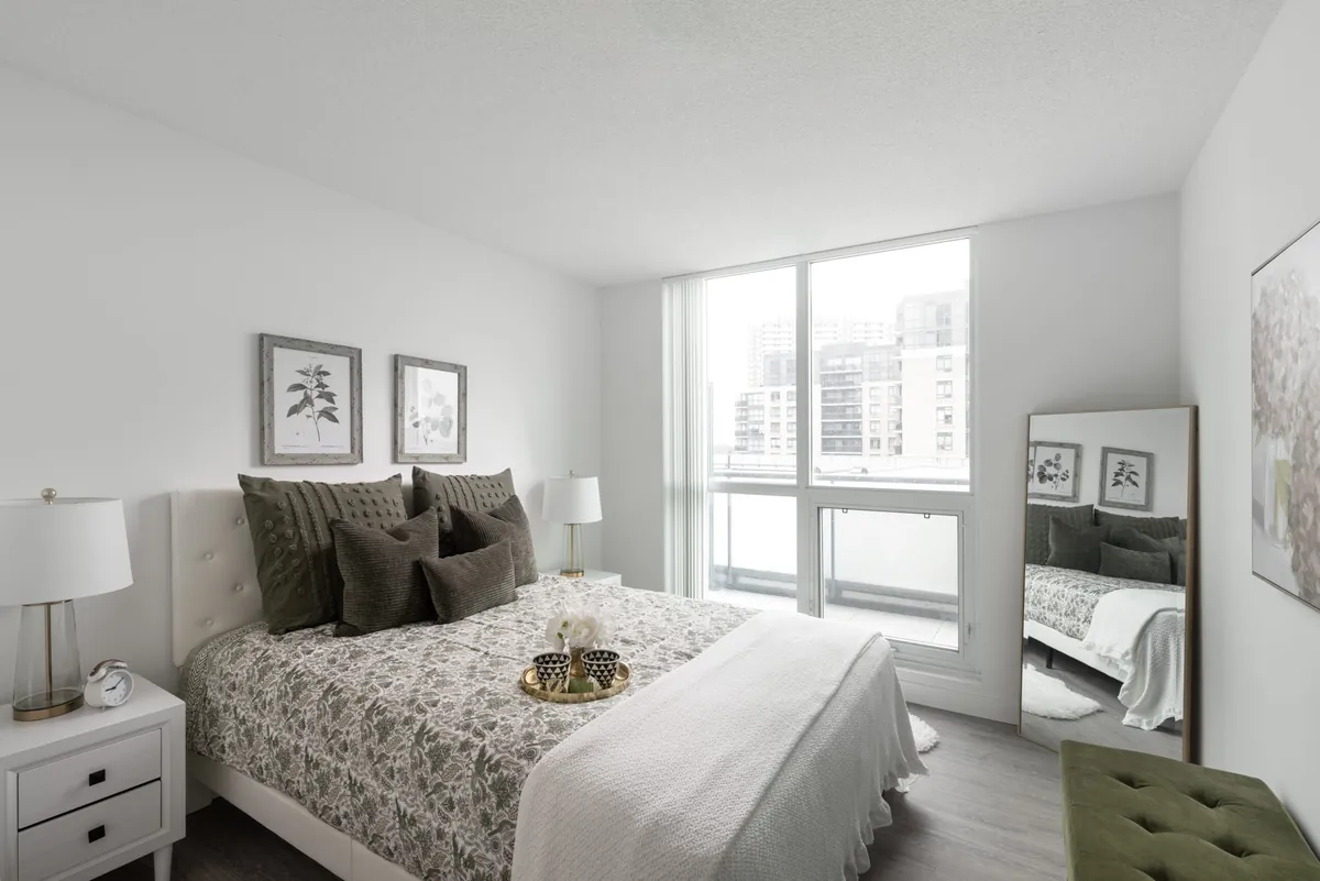 Ensuite master bedroom with a queen bed against a window wall
