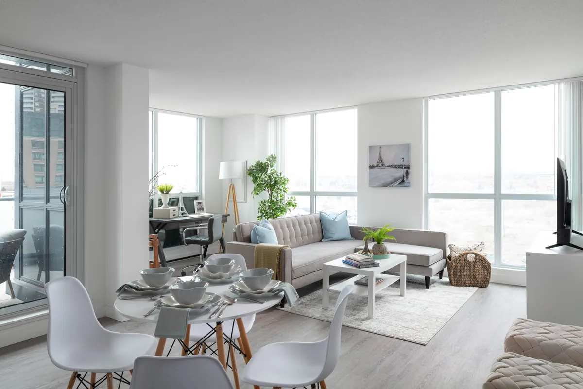A furnished living area with floor-to-ceiling windows